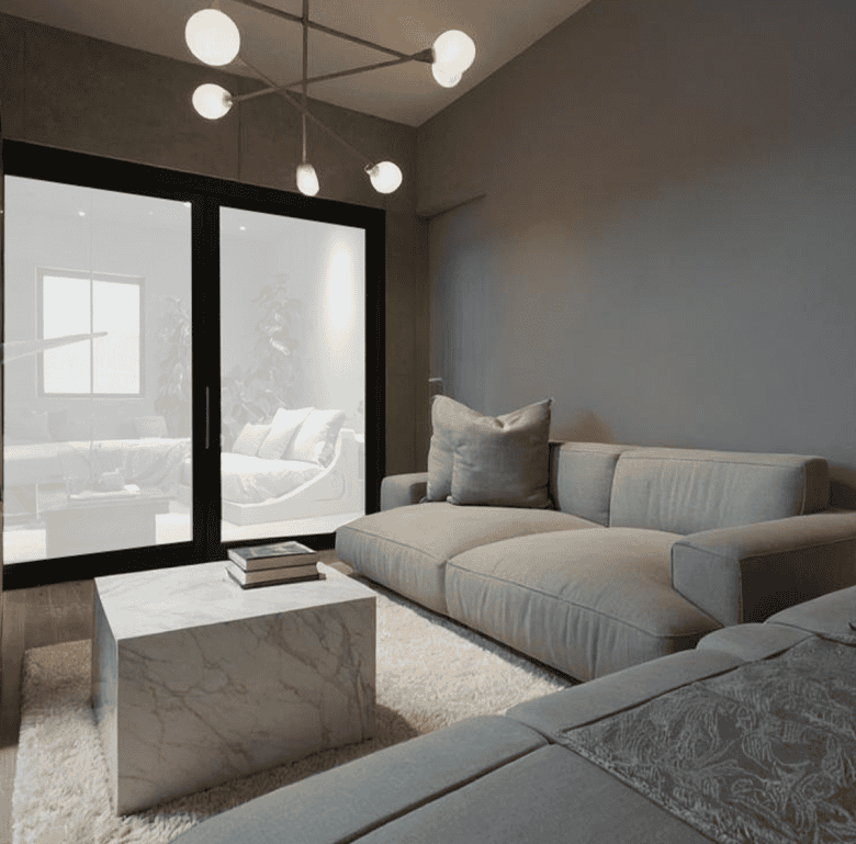 Spacious living room with contemporary furniture and large glass doors in Portside Residences, Athen.
