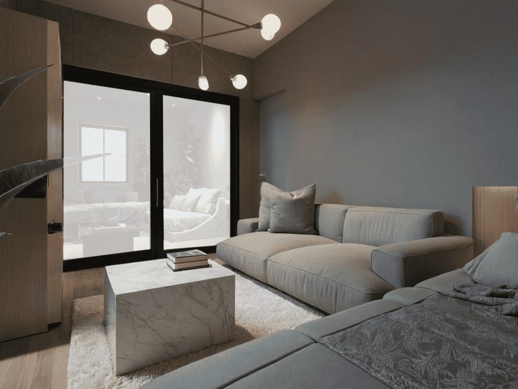 Spacious living room with contemporary furniture and large glass doors in Portside Residences, Athen.