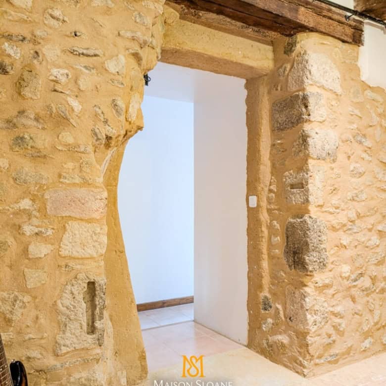 Elegant stone archway in a rustic French countryside home.
