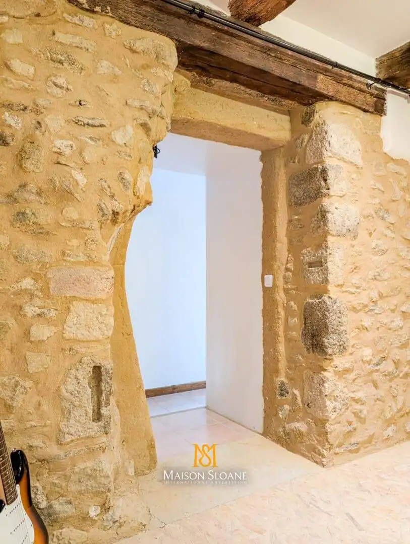 Elegant stone archway in a rustic French countryside home.
