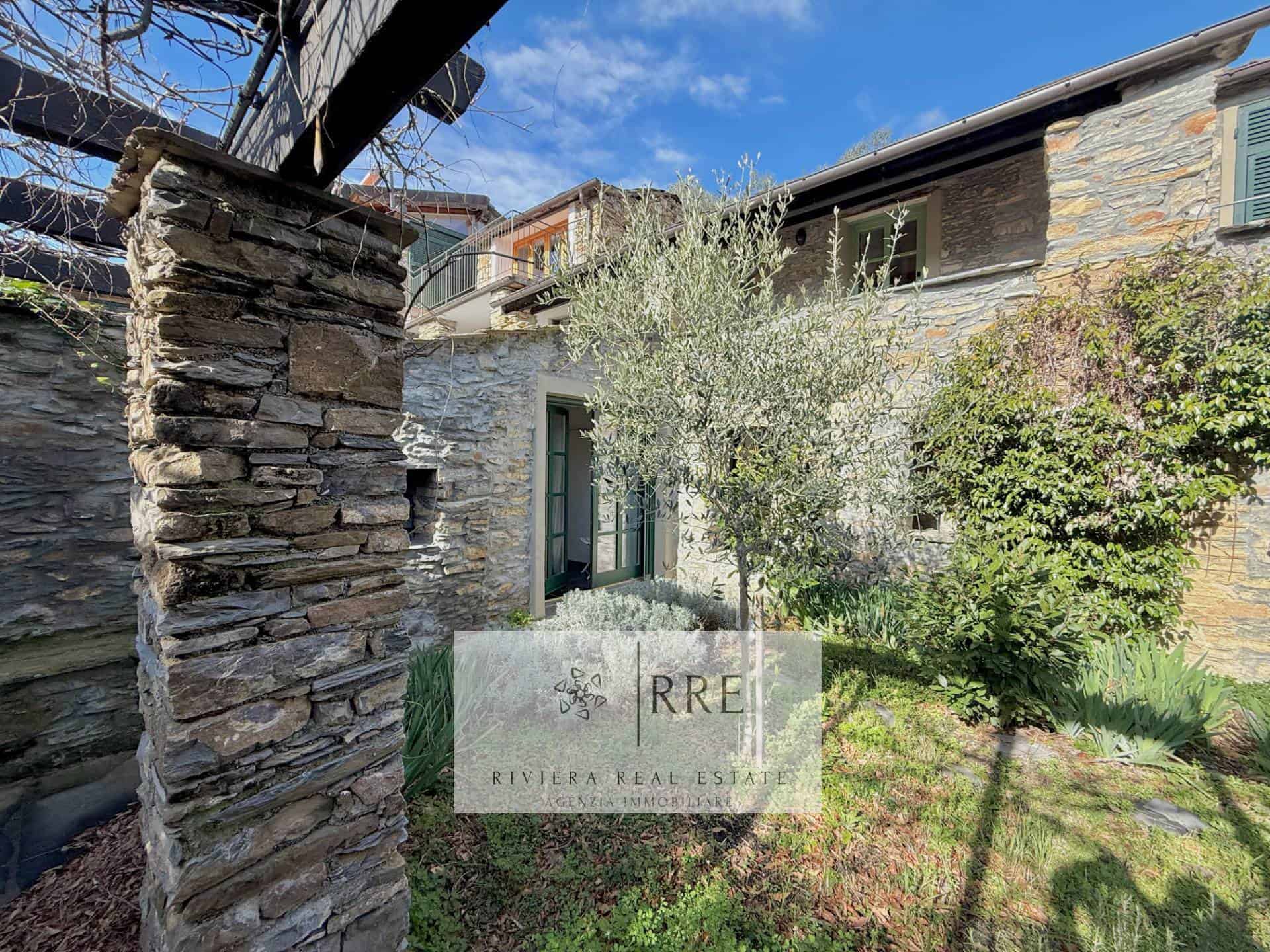 Beautiful stone house with lush garden and outdoor space.