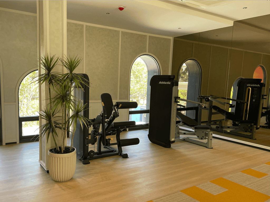 Gym room in Hua Hin cabanas with fitness equipment and natural light.