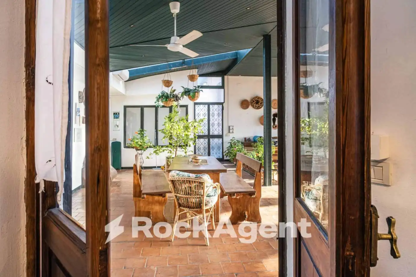 Elegant villa interior with spacious dining area and lush greenery views.