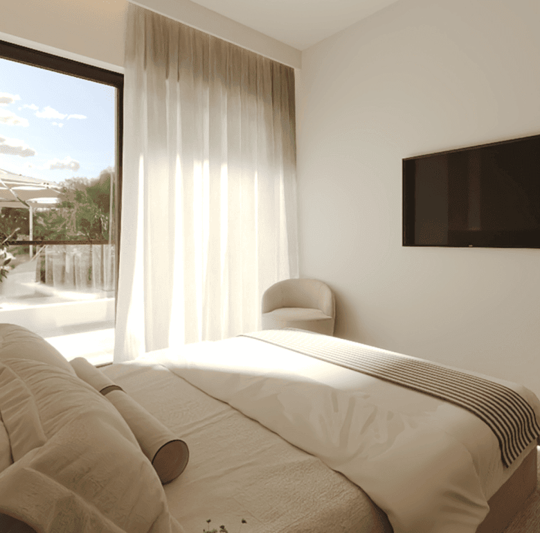 Bright bedroom with large window overlooking outdoor terrace in Algarve, Portugal.