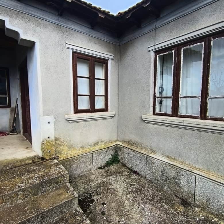 Exterior view of a house with wooden window frames near the Black Sea.