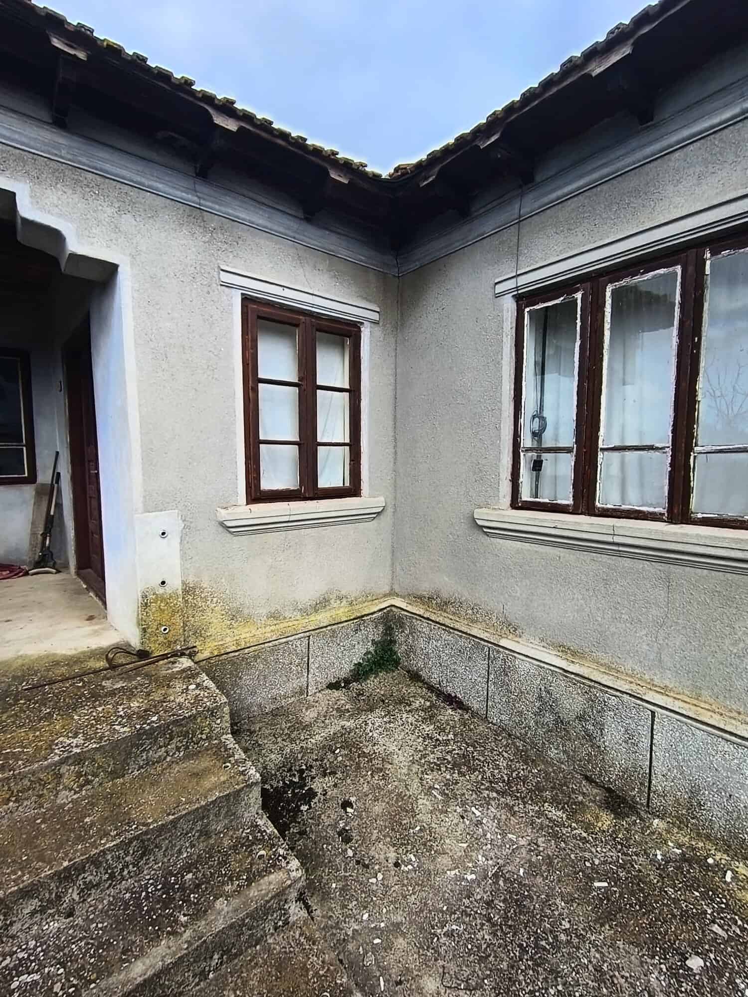 Exterior view of a house with wooden window frames near the Black Sea.