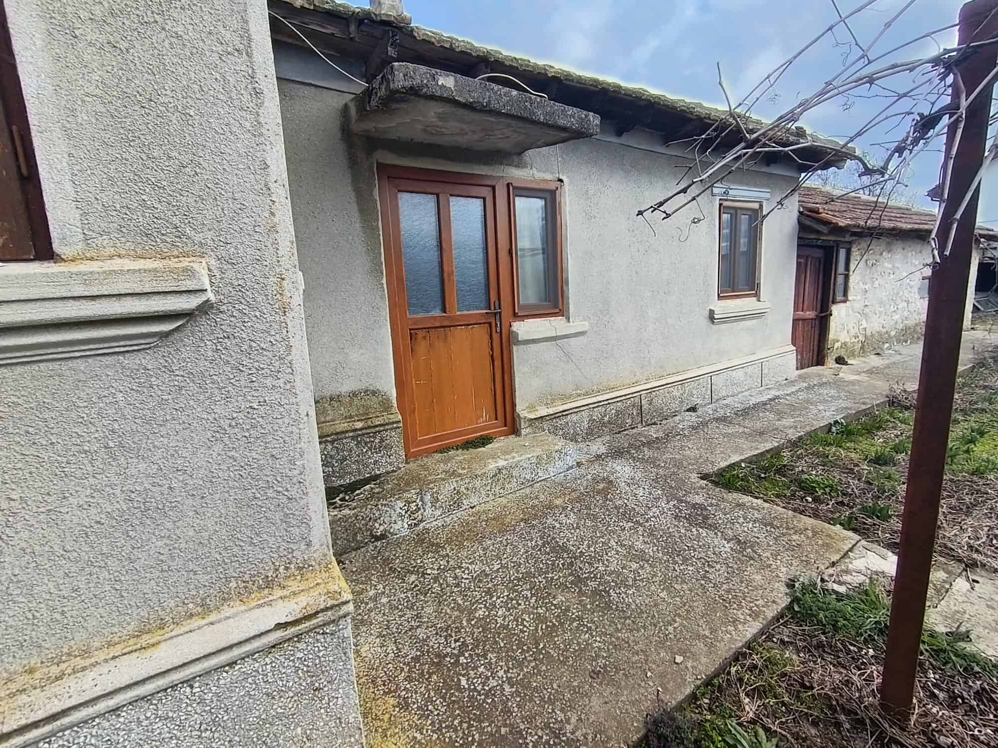 Traditional rural house with wooden door and small windows near the Black Sea.