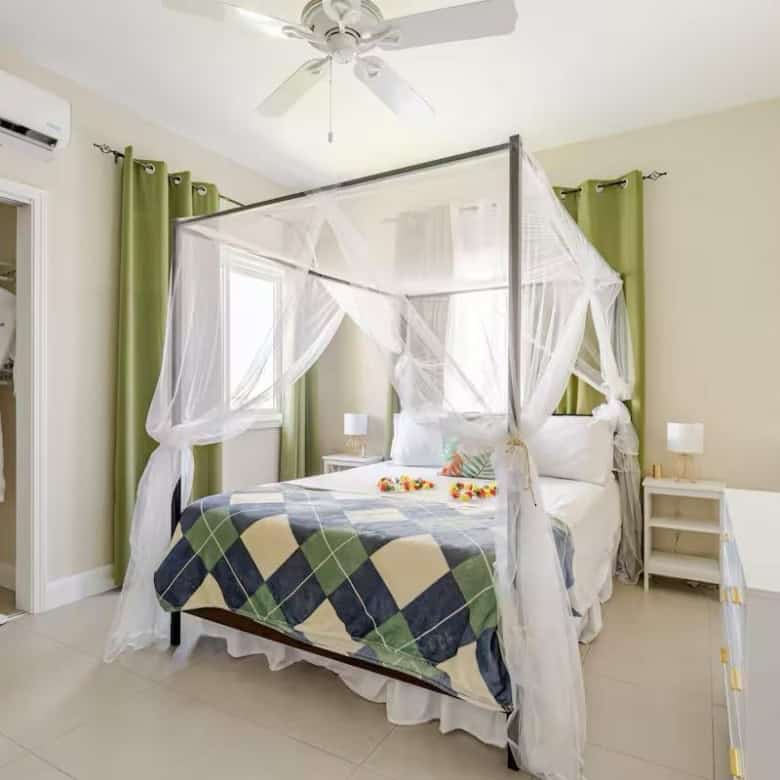 Elegant bedroom with a canopy bed and ocean views.