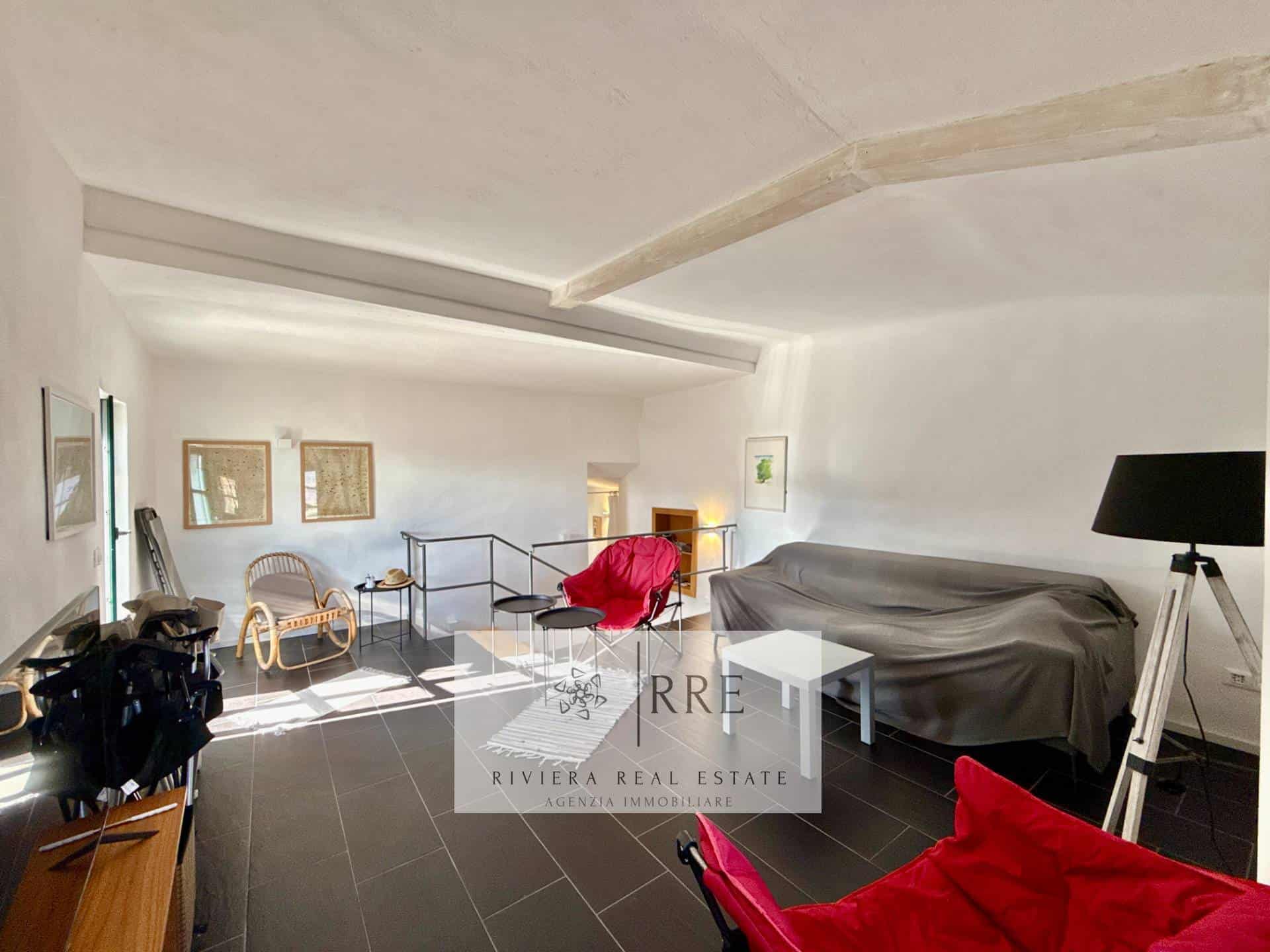 Attic apartment with cozy living area, stylish decor, and natural light.