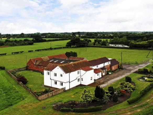 Beautiful countryside farmhouse with extensive land and lush gardens. Perfect for rural living or in.