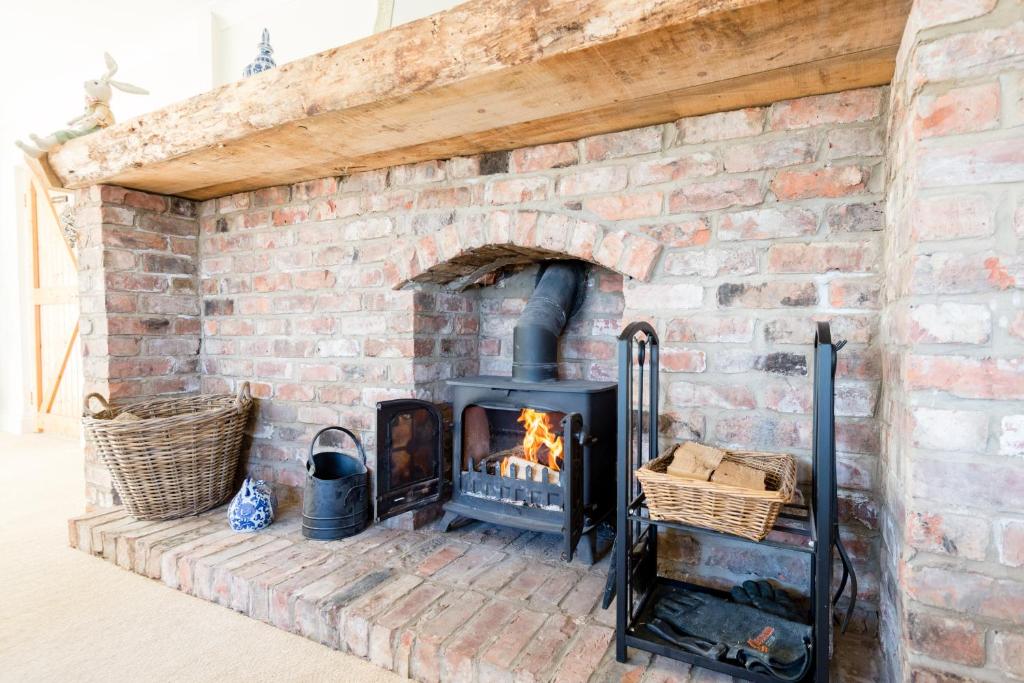Cozy Brick Fireplace with Wood Storage Traditional brick fireplace with a warm fire and wood storage area.