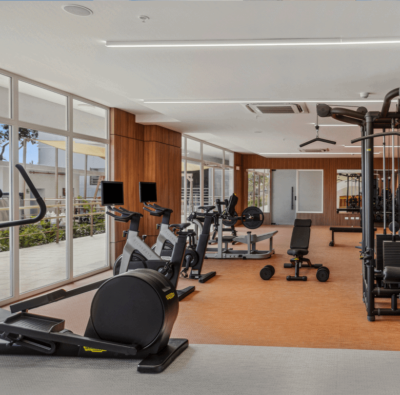 Gym interior with cardio and strength training equipment at Surfside - Playa Caracol, Panama.