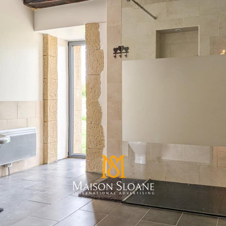 Elegant bathroom with modern fixtures and natural light.