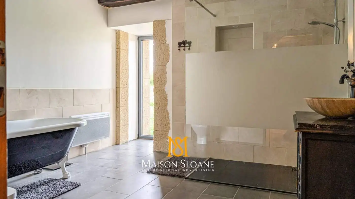 Elegant bathroom with modern fixtures and natural light.