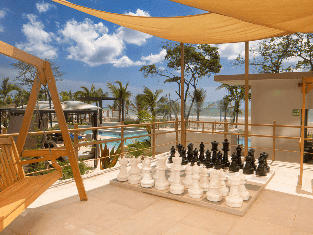 Beachfront terrace with chess and shaded seating area in Surfside, Playa Caracol, Panama.