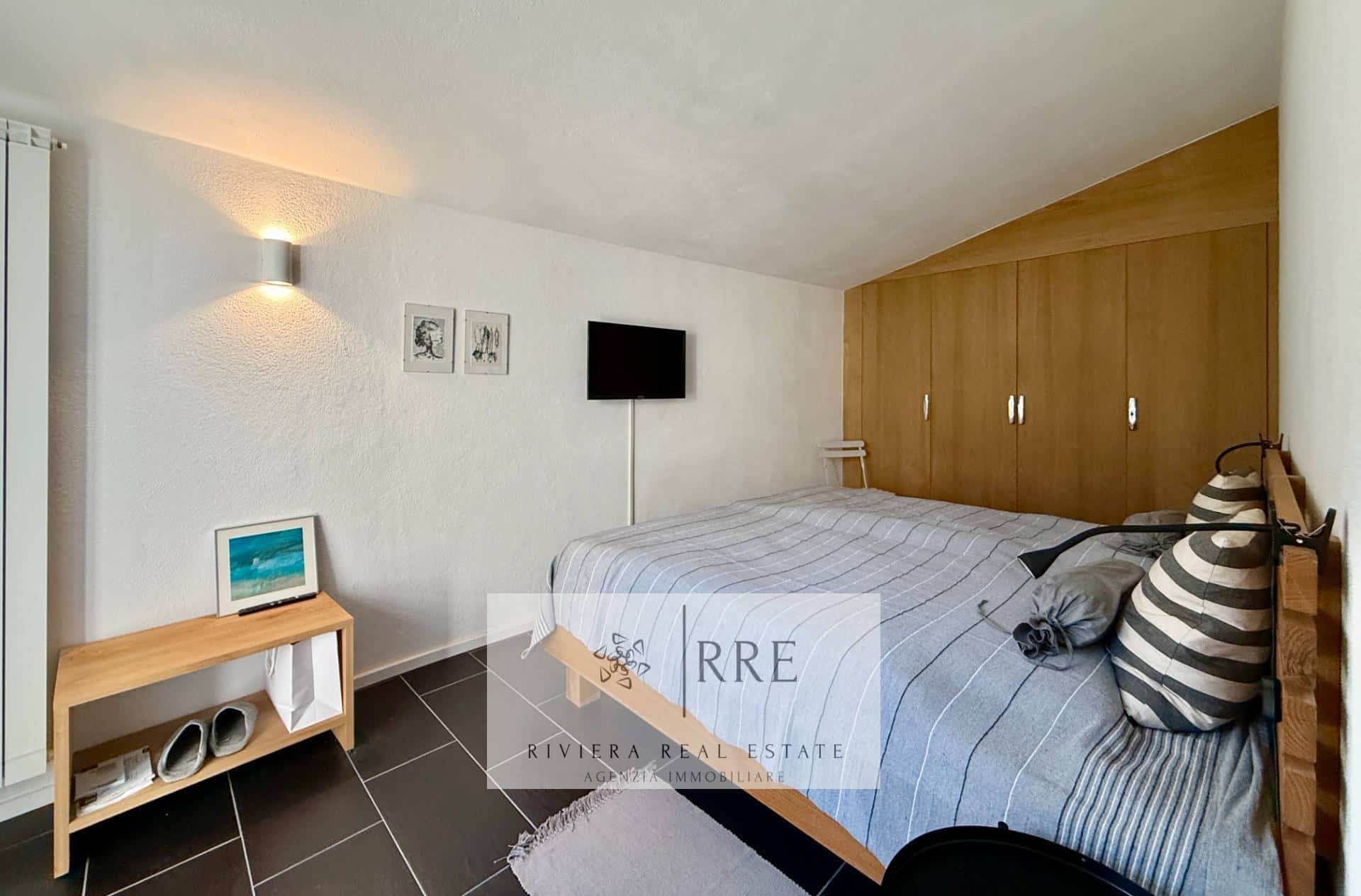 Bright bedroom with minimalist design and comfortable bed.