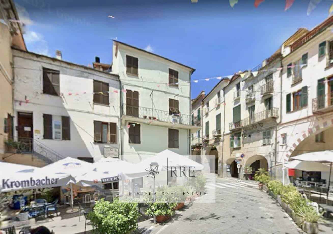 Beautiful historic village square with colorful buildings and outdoor cafes.