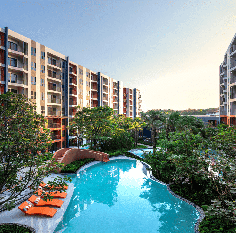 Contemporary Hua Hin condo featuring a swimming pool and landscaped gardens.