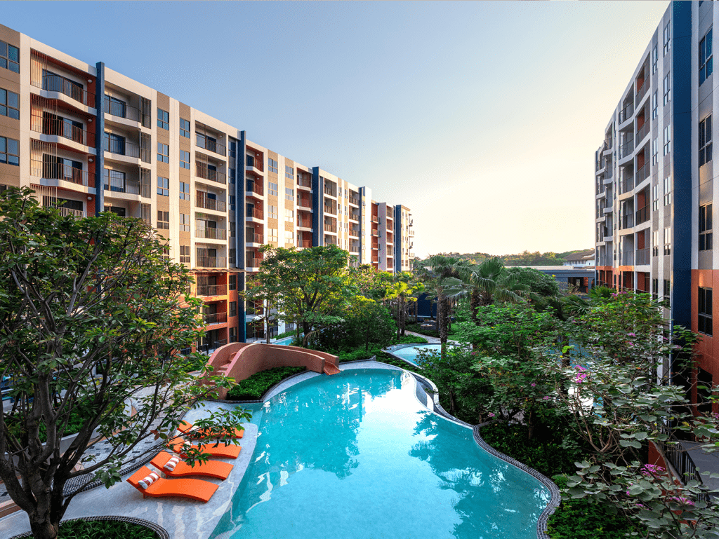 Contemporary Hua Hin condo featuring a swimming pool and landscaped gardens.