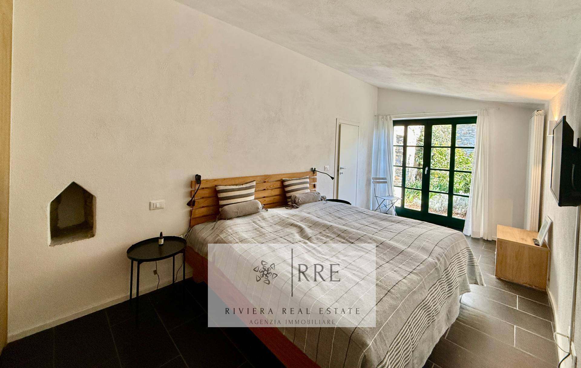 Bright bedroom featuring a large window and minimalist decor. Perfect for relaxing and enjoying scen.