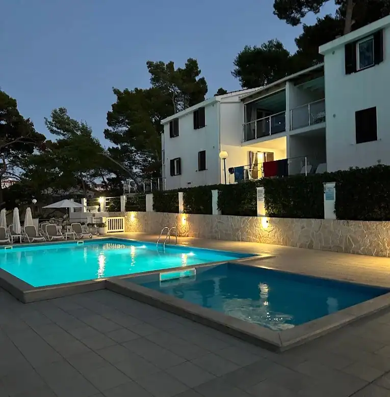 Poolside view of a luxury 2-bedroom apartment in Lumbarda Resort, Korčula, Croatia.