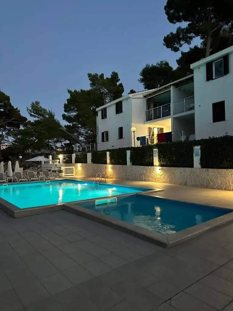 Luxury 2 Bed Apartment Pool View Poolside view of a luxury 2-bedroom apartment in Lumbarda Resort, Korčula, Croatia.