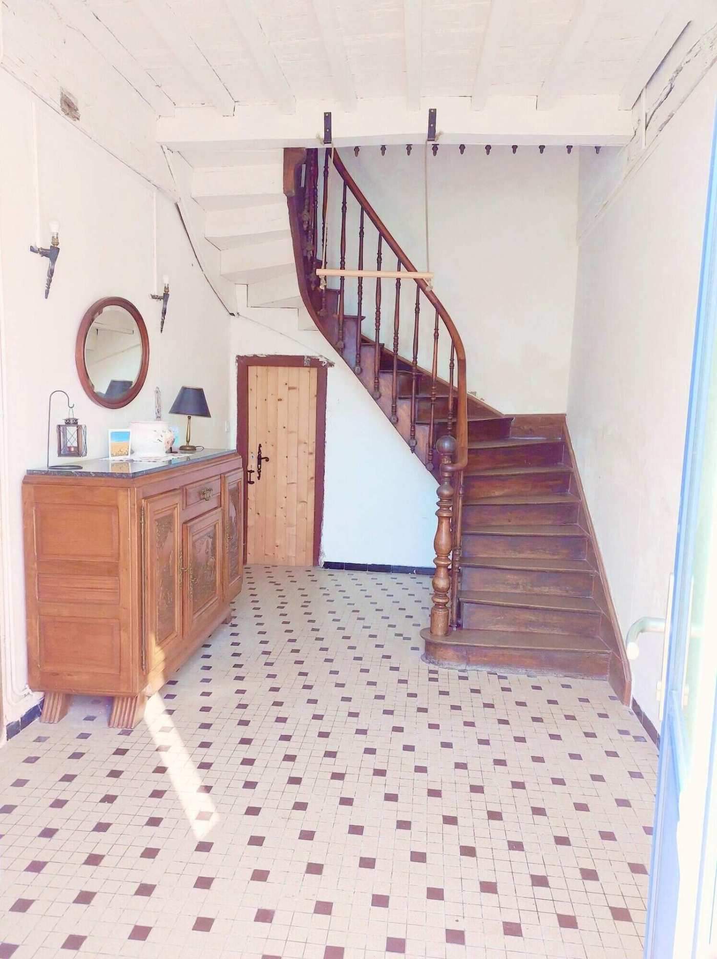 Charming Farmhouse Interior in Madiran France Cozy farmhouse interior with wooden staircase and vintage furniture in Madiran village, France.