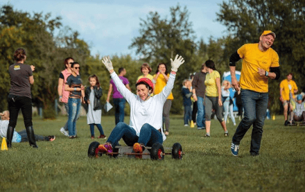 Group of people enjoying outdoor activities at Valmoniras farm in Latvia.