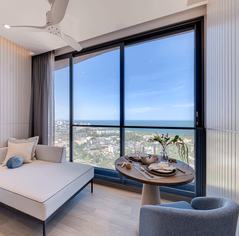 Sea view apartment in Hua Hin, Thailand with floor-to-ceiling windows and contemporary interior desi.