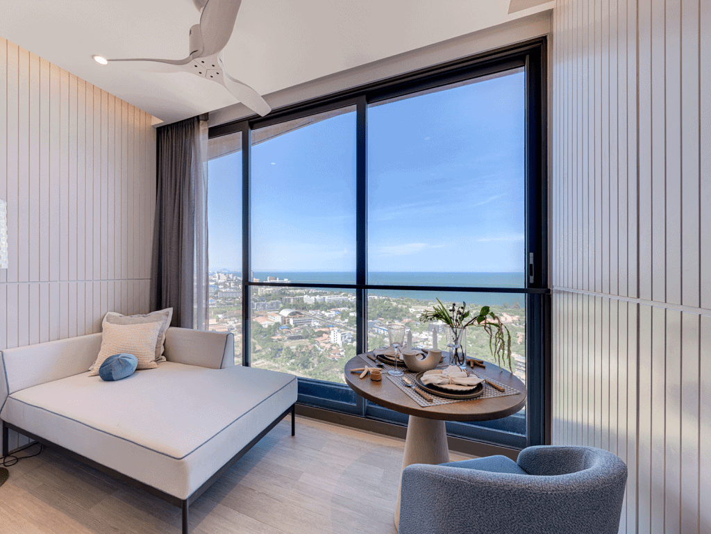 Sea view apartment in Hua Hin, Thailand with floor-to-ceiling windows and contemporary interior desi.