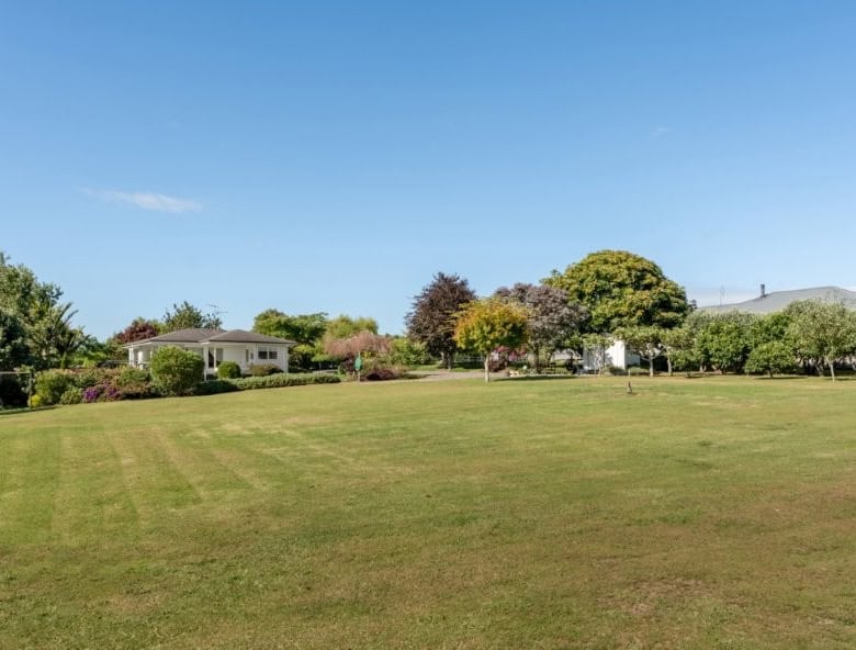 Beautiful cottage estate with lush green lawns and mature trees in Tauranga, Bay of Plenty, New Zeal.