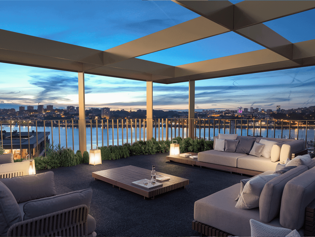 Rooftop terrace in Porto, Portugal, with modern outdoor furniture and panoramic city views at sunset.