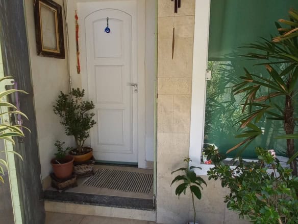 Entrance door with plants and decor.