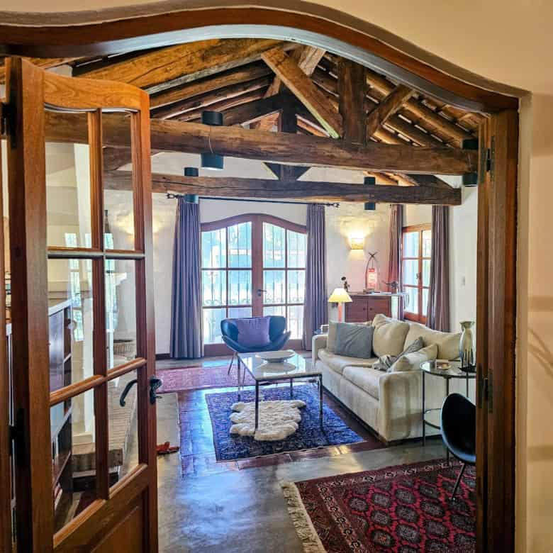 Beautiful rustic living room featuring exposed wooden beams and large windows. Perfect for relaxing.