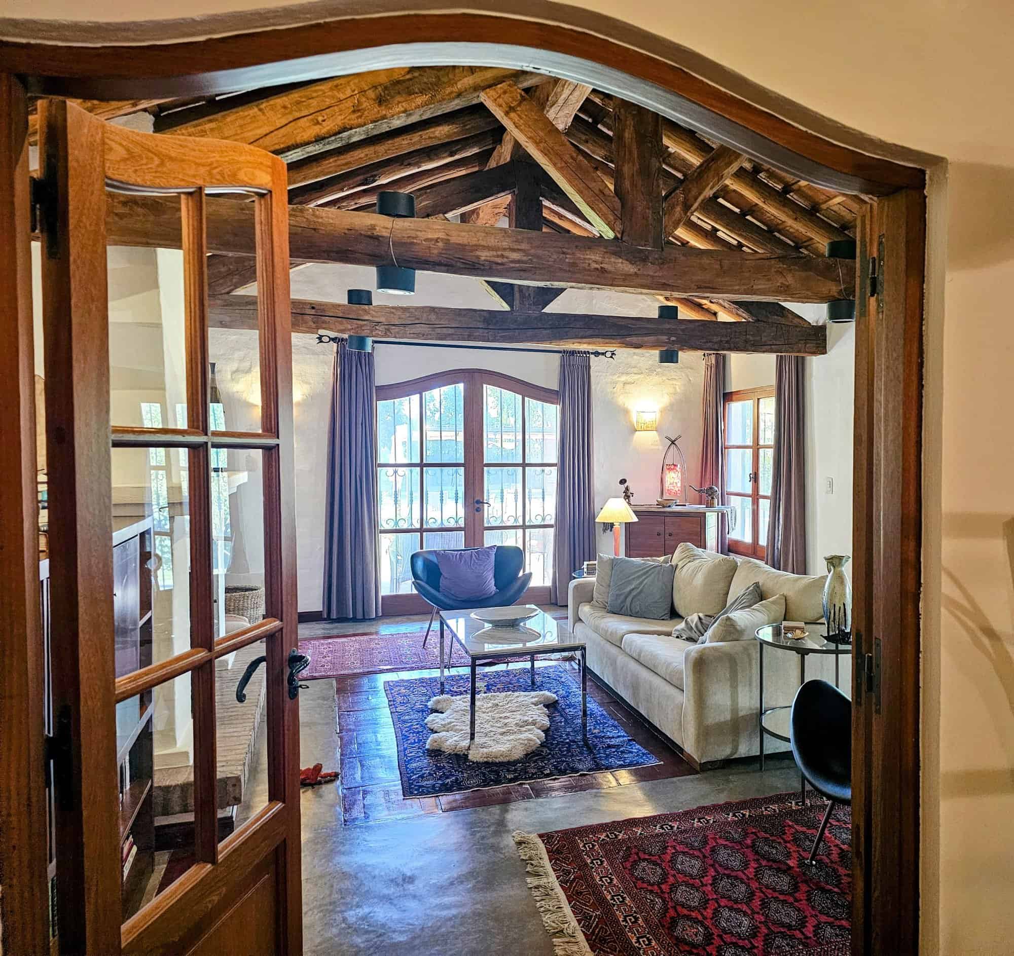 Cozy Rustic Living Room with Wooden Beams Beautiful rustic living room featuring exposed wooden beams and large windows. Perfect for relaxing.
