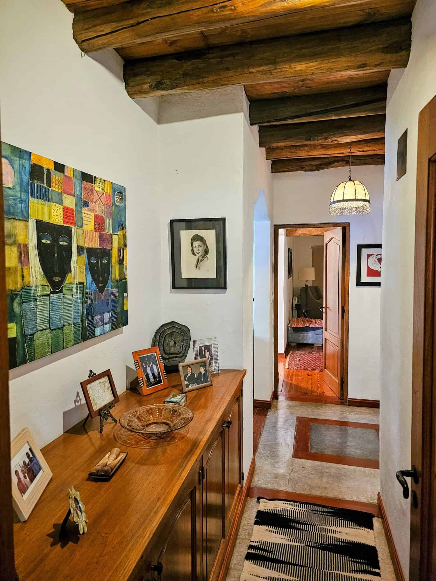 Cozy Rustic Interior with Wooden Ceiling Beams Interior hallway with wooden ceiling beams and artwork.