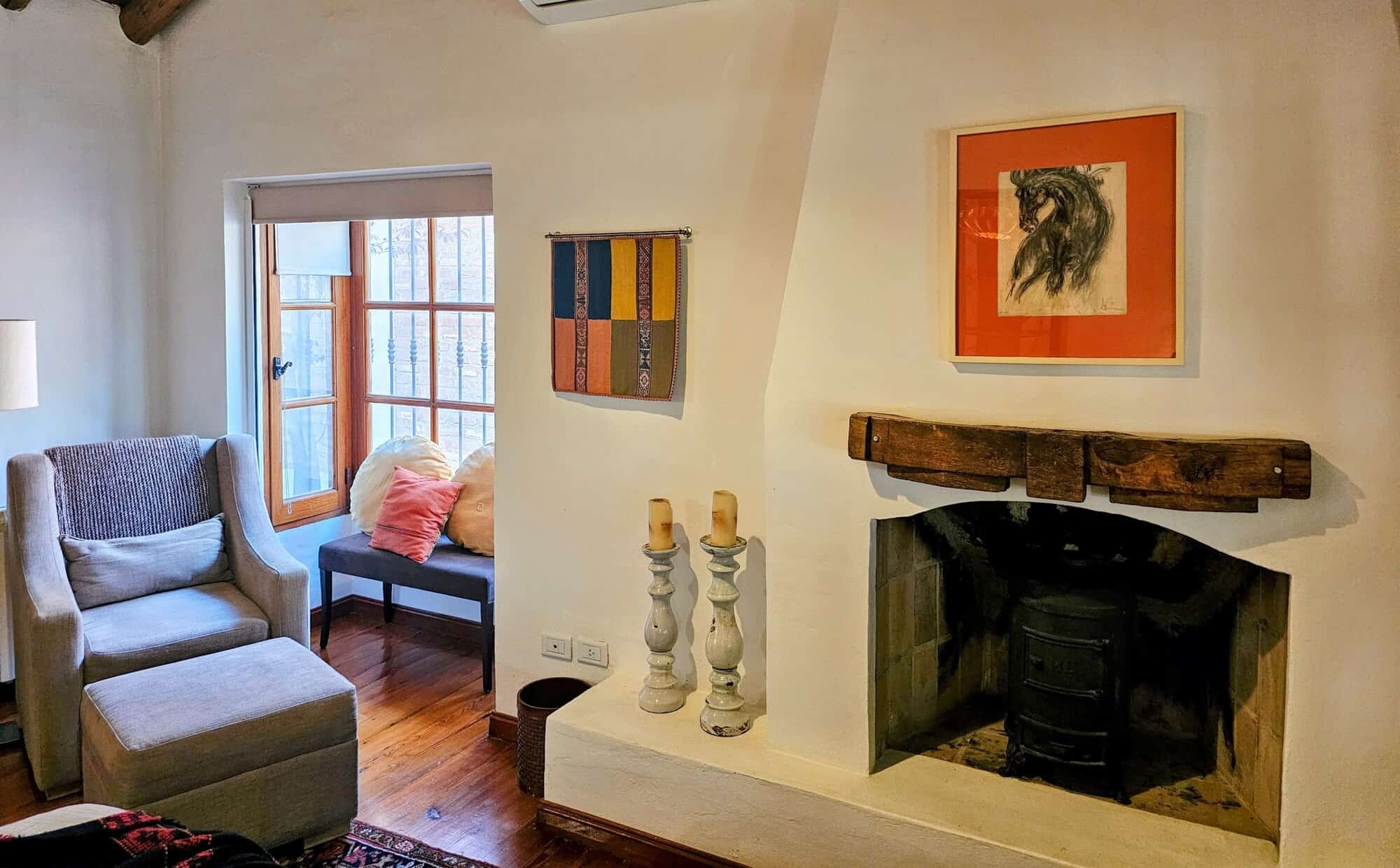 Cozy Living Room with Fireplace and Artwork Cozy living room featuring a fireplace, colorful artwork, and comfortable seating in a bright, invit.