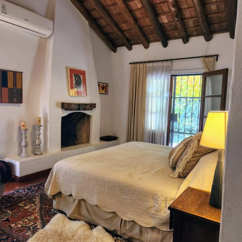 Cozy bedroom featuring a wooden ceiling, natural light, and elegant decor for a peaceful home enviro.