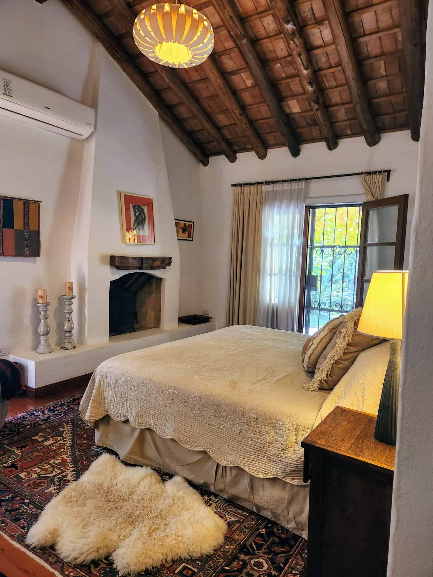 Charming Rustic Bedroom with Wooden Ceiling Cozy bedroom featuring a wooden ceiling, natural light, and elegant decor for a peaceful home enviro.