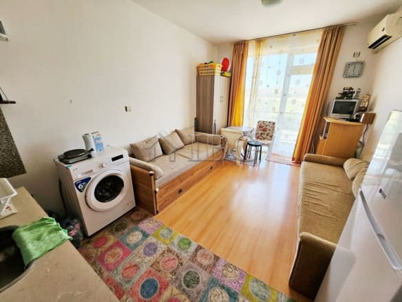 Furnished studio apartment with bright sunlight, modern amenities, and a comfortable living space ne.