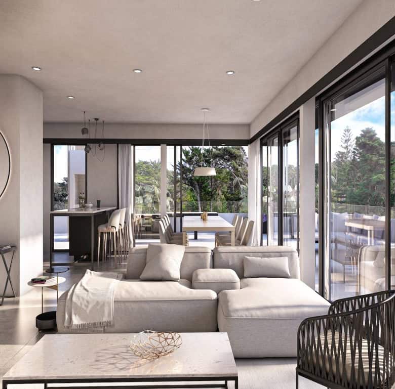 Modern living room with expansive glass windows overlooking lush greenery in Altos, Punta del Este,.