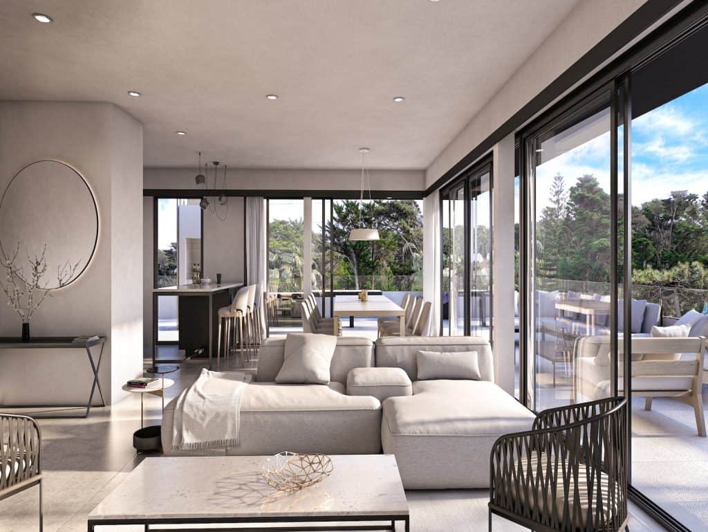 Modern living room with expansive glass windows overlooking lush greenery in Altos, Punta del Este,.