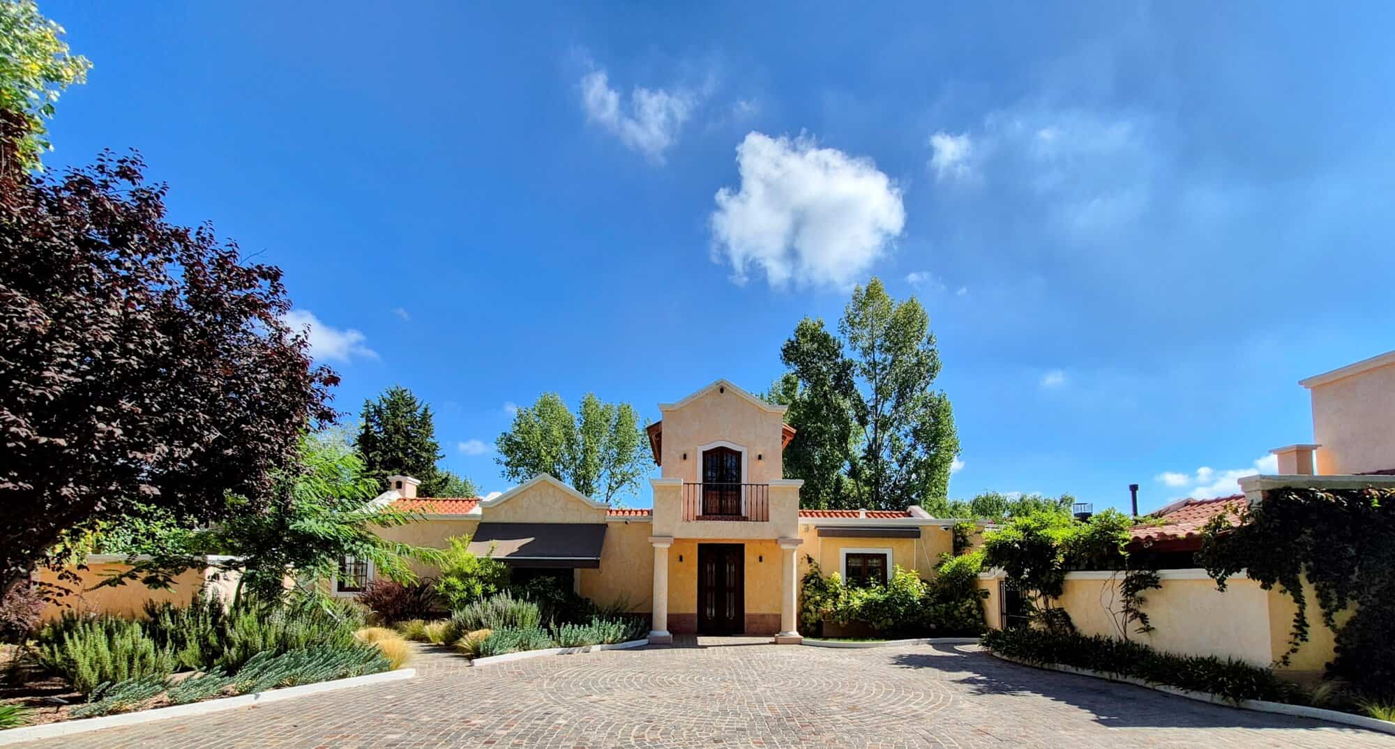 Luxury Spanish Villa with Garden and Pool Elegant Spanish villa with lush garden and swimming pool in a sunny setting.