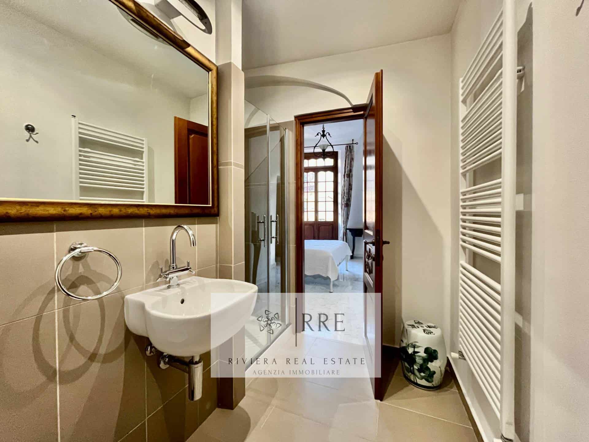 Bathroom with shower, mirror, and modern fixtures in a stylish home.