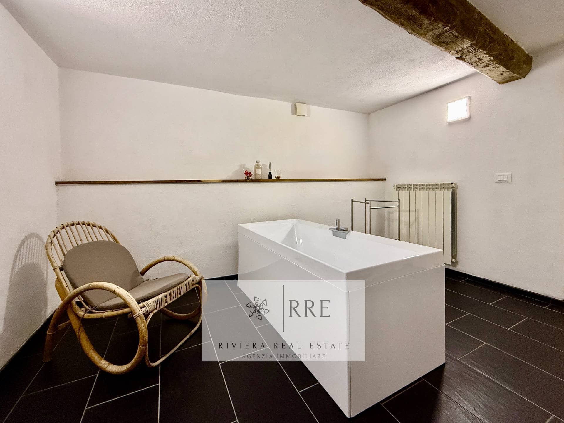 Modern bathroom with bathtub and rustic decor for sale in a charming property.