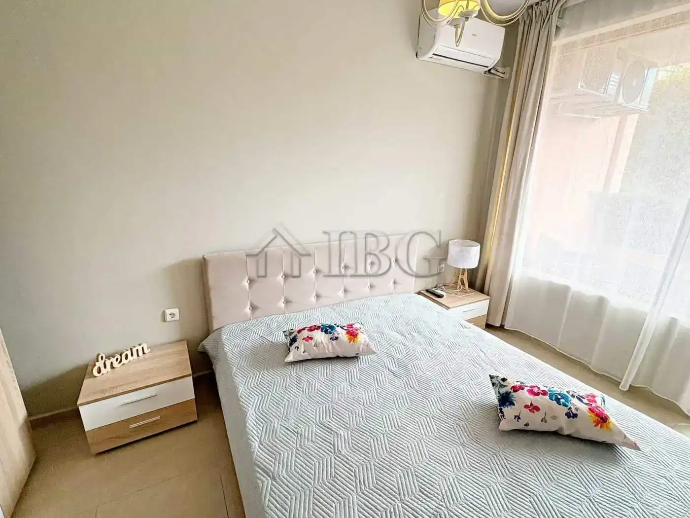 Modern bedroom with large window and air conditioning unit.