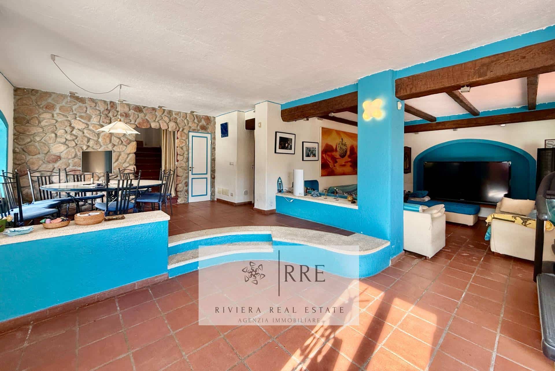 Bright living room with blue accents and stone wall, perfect for relaxing and entertaining.
