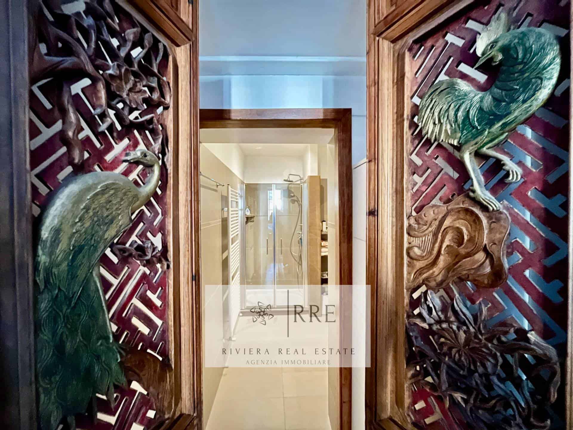 Carved historic interior door — original detail of the Pieve di Teco property.
