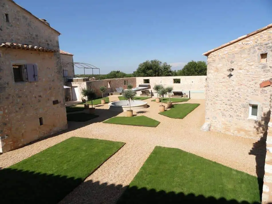 Elegant estate with lush gardens and stone buildings in Goudargues, Le Gard, France.