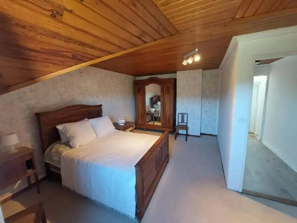 Charming Farmhouse Bedroom in Madiran France Cozy bedroom in a traditional farmhouse located in Madiran Village, France, featuring wooden accents.